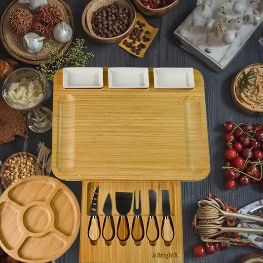 A cheese board made of bamboo, with knives and forks inside.